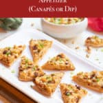 white platter with pita wedges topped with Artichoke, Sun-Dried Tomato and Feta Appetizer