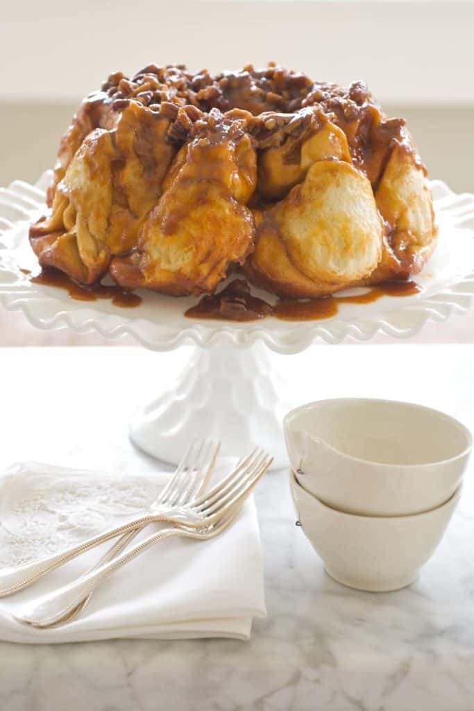 White cake pan holding Overnight Bundt Caramel Rolls