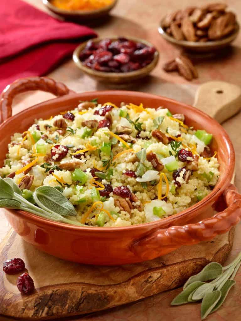Coral round ceramic dish filled with Couscous with Dried Cranberries and Pecans