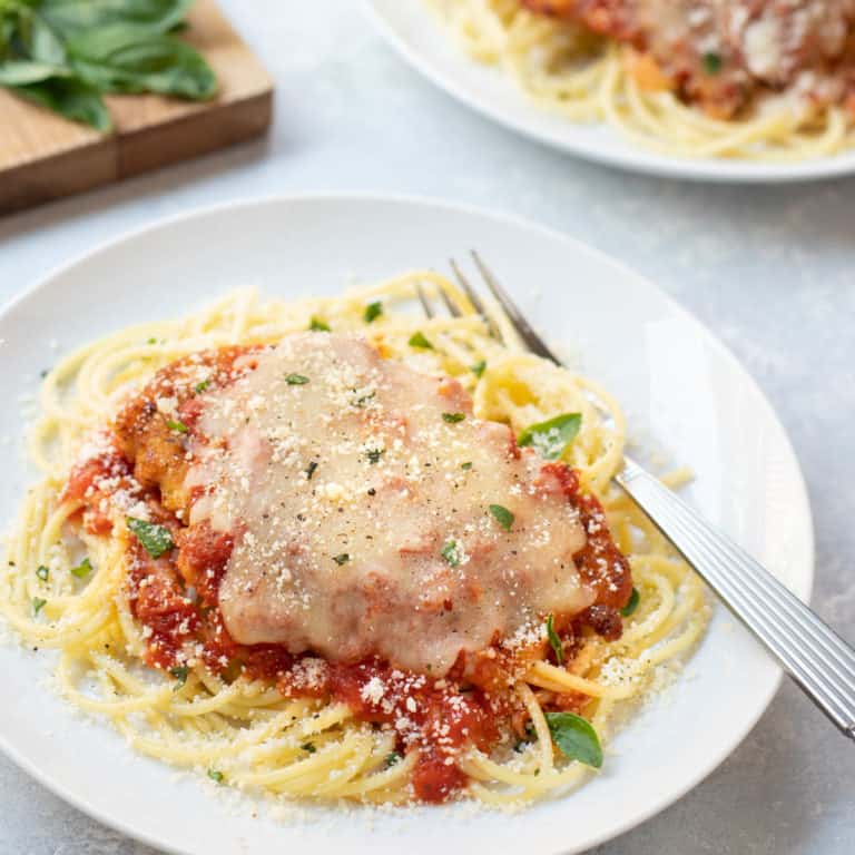 Breaded chicken breast covered with marinara sauce and melted cheese, atop cooked spaghetti