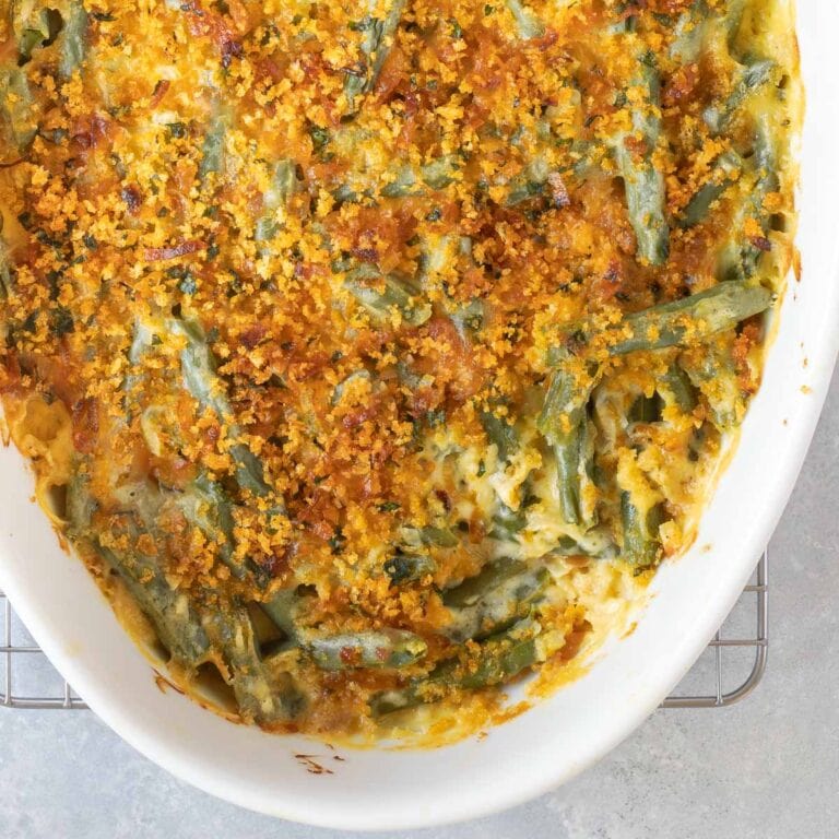Close up of Fresh Green Bean Casserole with a corner of the topping removed to show what's underneath