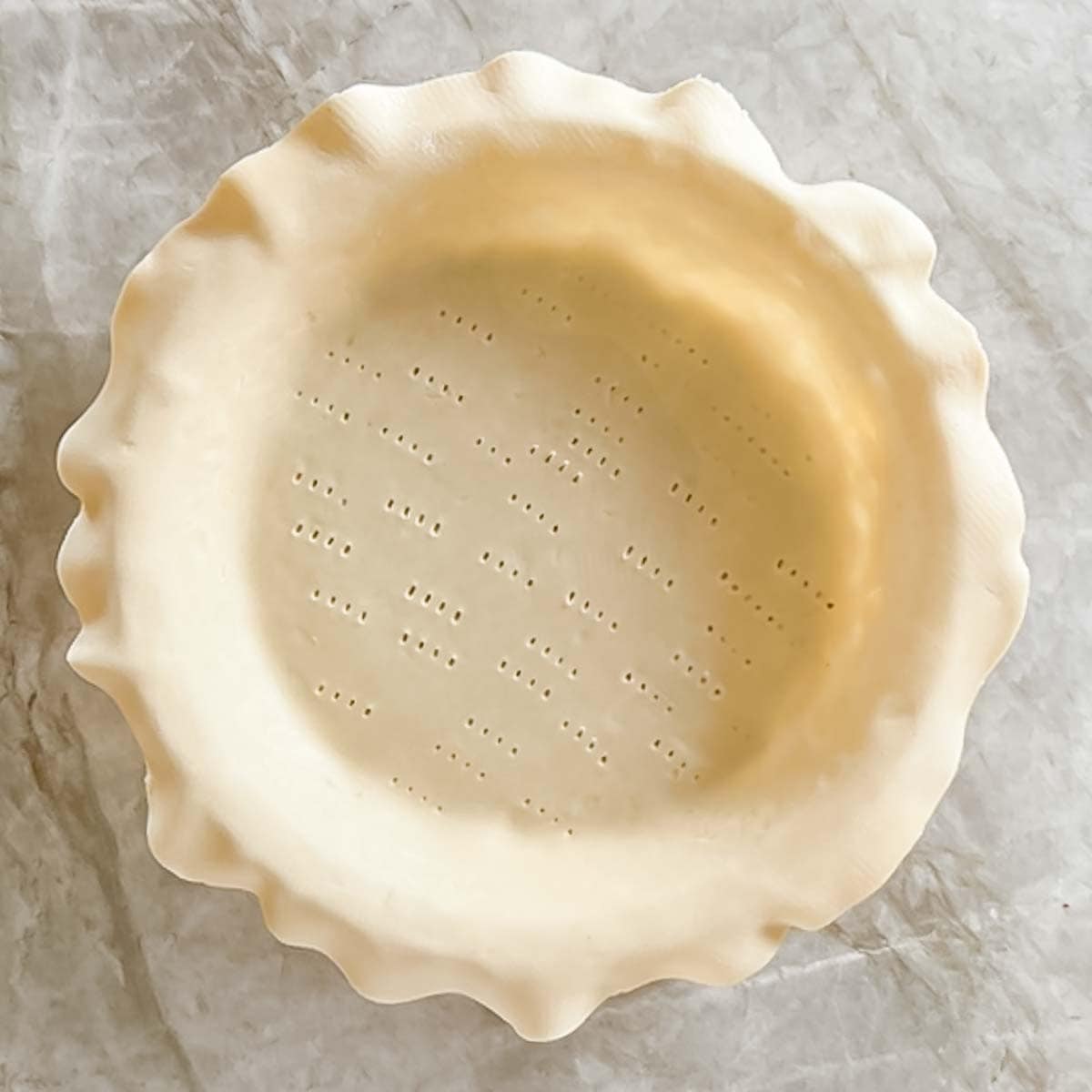 bottom crust for pie in pie dish, edges trimmed and bottom pricked with a fork in several places