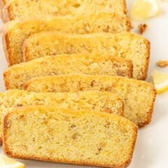 Eight slices of lemon bread, arranged overlapping on a white background.