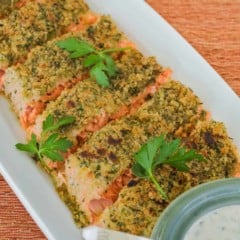 overhead showing slices of Parmesan Crusted Salmon with bowl of Herb Mayo