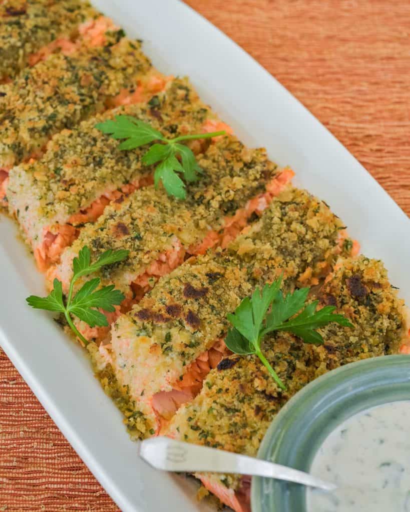 overhead showing slices of Parmesan Crusted Salmon with bowl of Herb Mayo