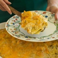 Scoop of crab and shrimp lasagna above dish