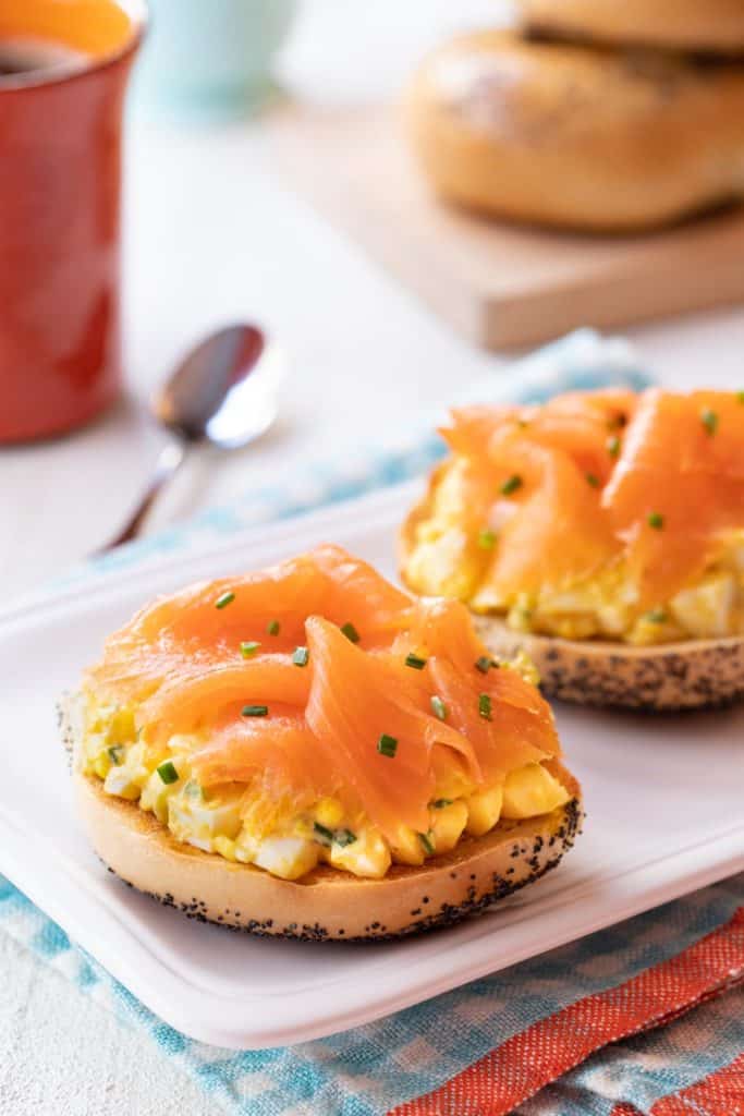 White platter with Toasted Bagels with Egg Salad and Smoked Salmon