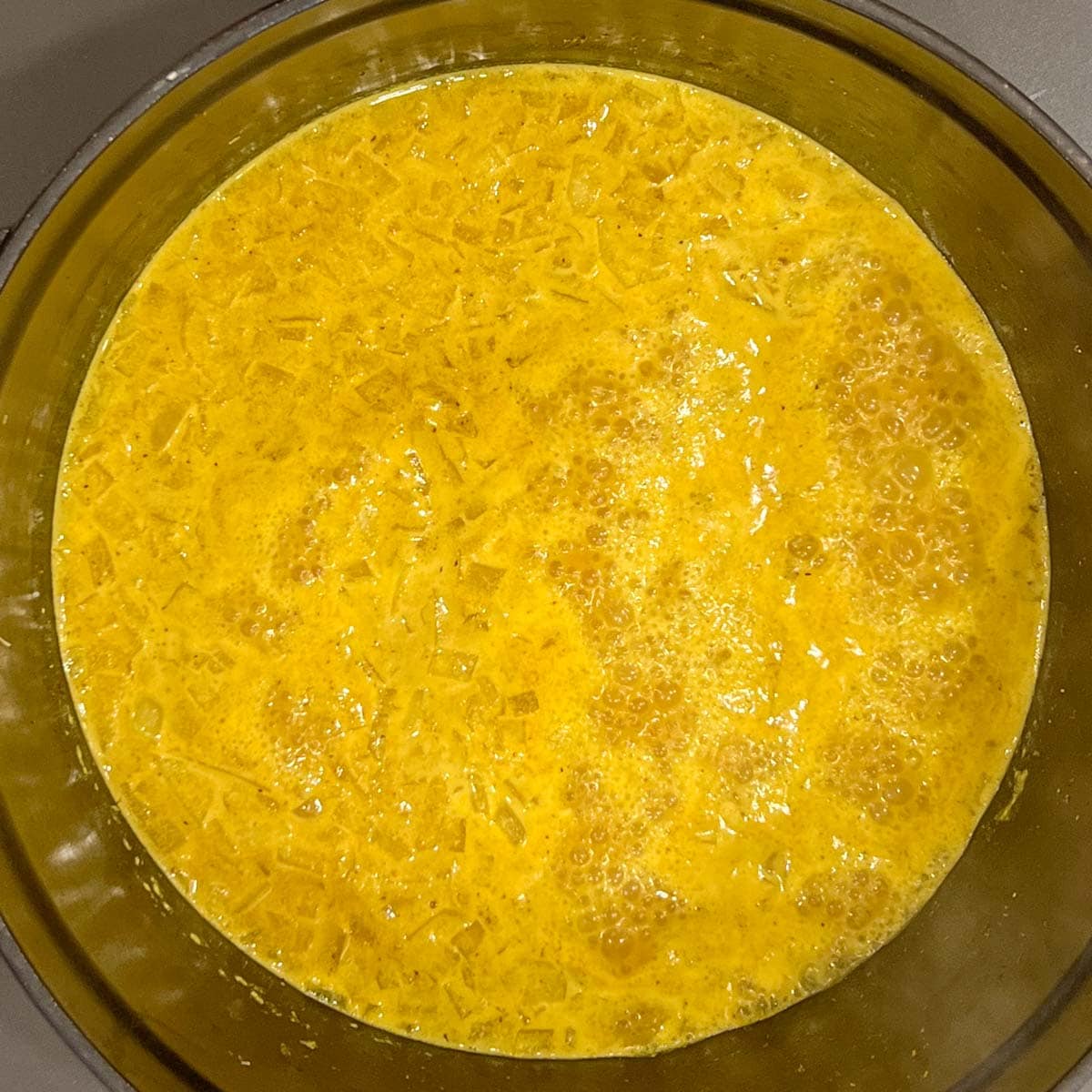Overhead view of simmering curry sauce for Mixed Vegetable Curry